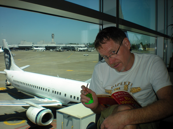 The King of Crosswords waits for his flight to Vancouver.