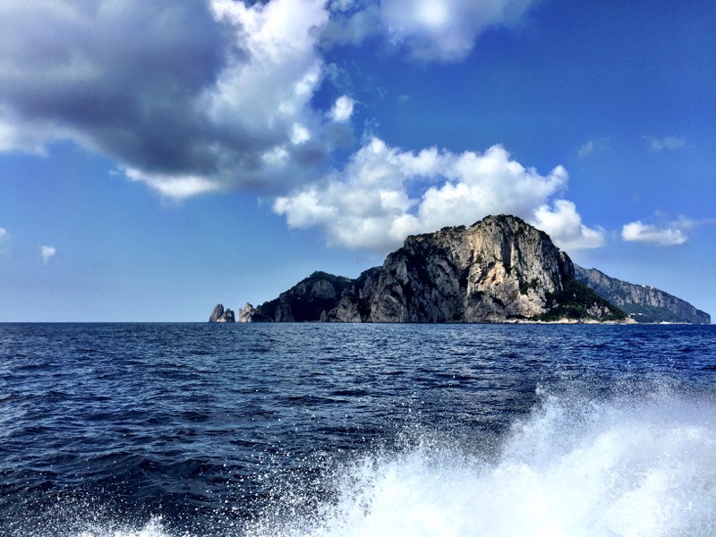 Approaching the Isle of Capri from Positano. I Faraglione is seen at the left of the island. 