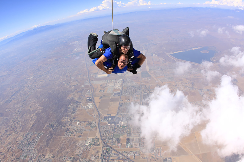 Falling at over 120 MPH. The initial chute is open. My flabby face is flapping in the wind. 